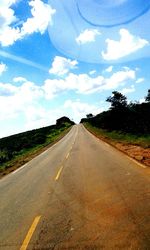 Empty road along trees