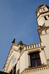 Low angle view of building against clear blue sky