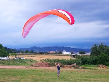 Full length of person paragliding against sky