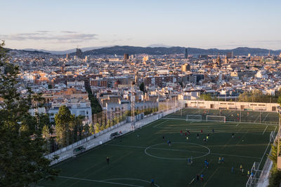 High angle view of soccer field against sky in city