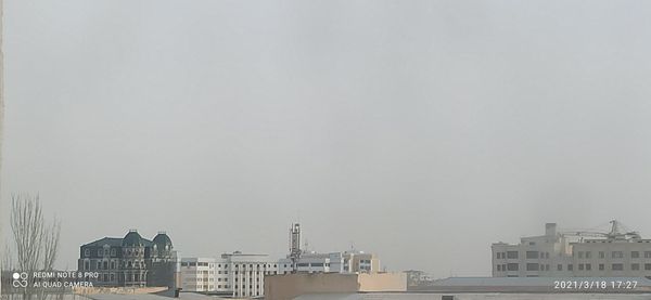 Buildings in city against clear sky