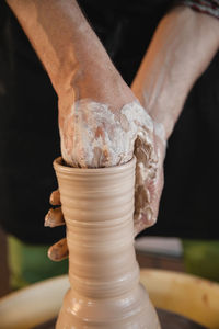 Cropped hand of man working at workshop