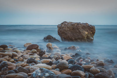 Rocks on beach against sky