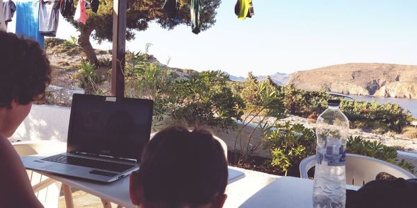 Rear view of man sitting on table