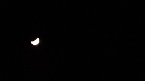 Low angle view of moon against clear sky at night