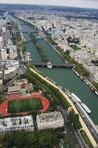High angle view of cityscape by river against sky