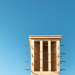 Low angle view of building against clear blue sky