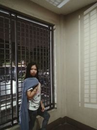 Portrait of teenage girl standing in building