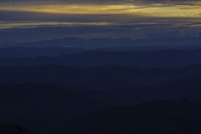 Scenic view of silhouette mountains against sky during sunset