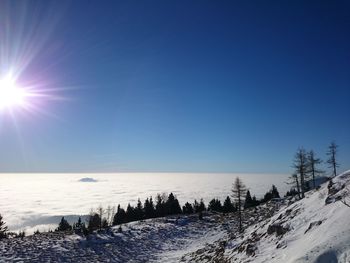 Scenic view of landscape against clear blue sky during winter