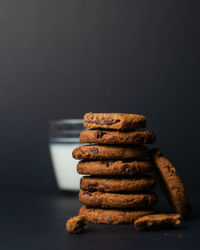 Close-up of cookies on table against black background