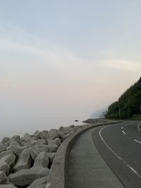 Road by sea against sky