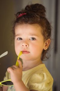 Portrait of cute girl holding sunglasses
