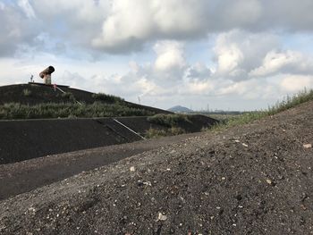 Scenic view of road by land against sky