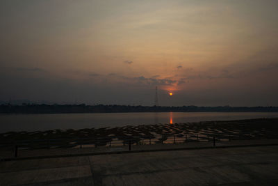 Pier over sea against sky during sunset