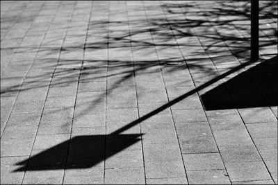 High angle view of shadow on footpath