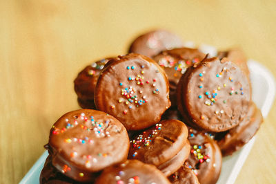 Gourmet chocolate covered oreos with colorful sprinkles on top.