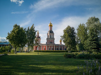 View of trees and building against sky. church of the life-giving trinity in sviblovo estate