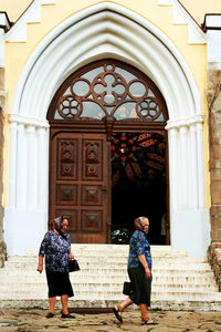 Rear view of people standing outside temple