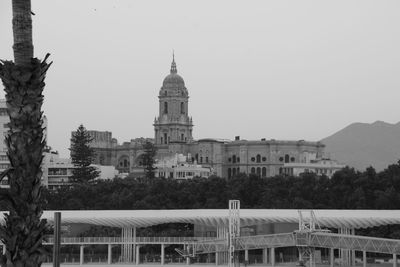 Buildings in city against clear sky