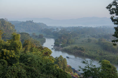 High angle view of river in forest against sky