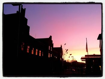 Buildings in city at sunset