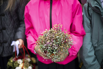 Bouquet of flowers in hands of child. flowers for holiday. details of holiday at school. 