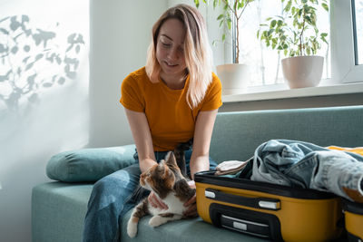 Portrait of boy with dog at home