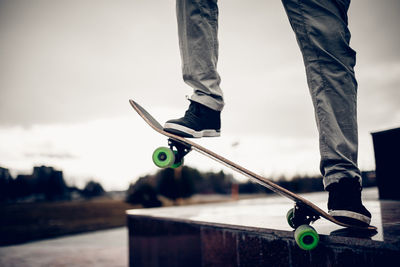 Low section of man skateboarding at park