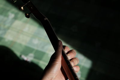 Close-up of person playing guitar