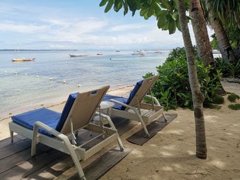 Two sunbeds with a nice view and fisher boats in background