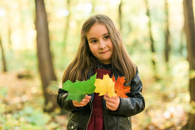 Portrait of smiling girl holding flower