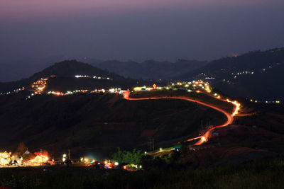 High angle view of illuminated city against sky at night