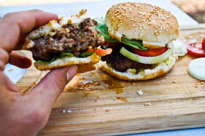 Cropped image of person holding burger