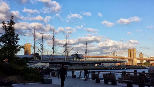 Bridge over river in city against sky