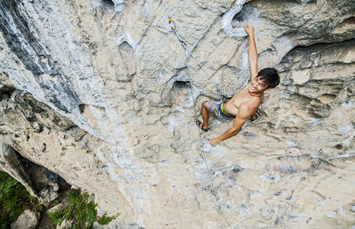 Man climbing on the limestone cliff "white mountain" in yangshuo