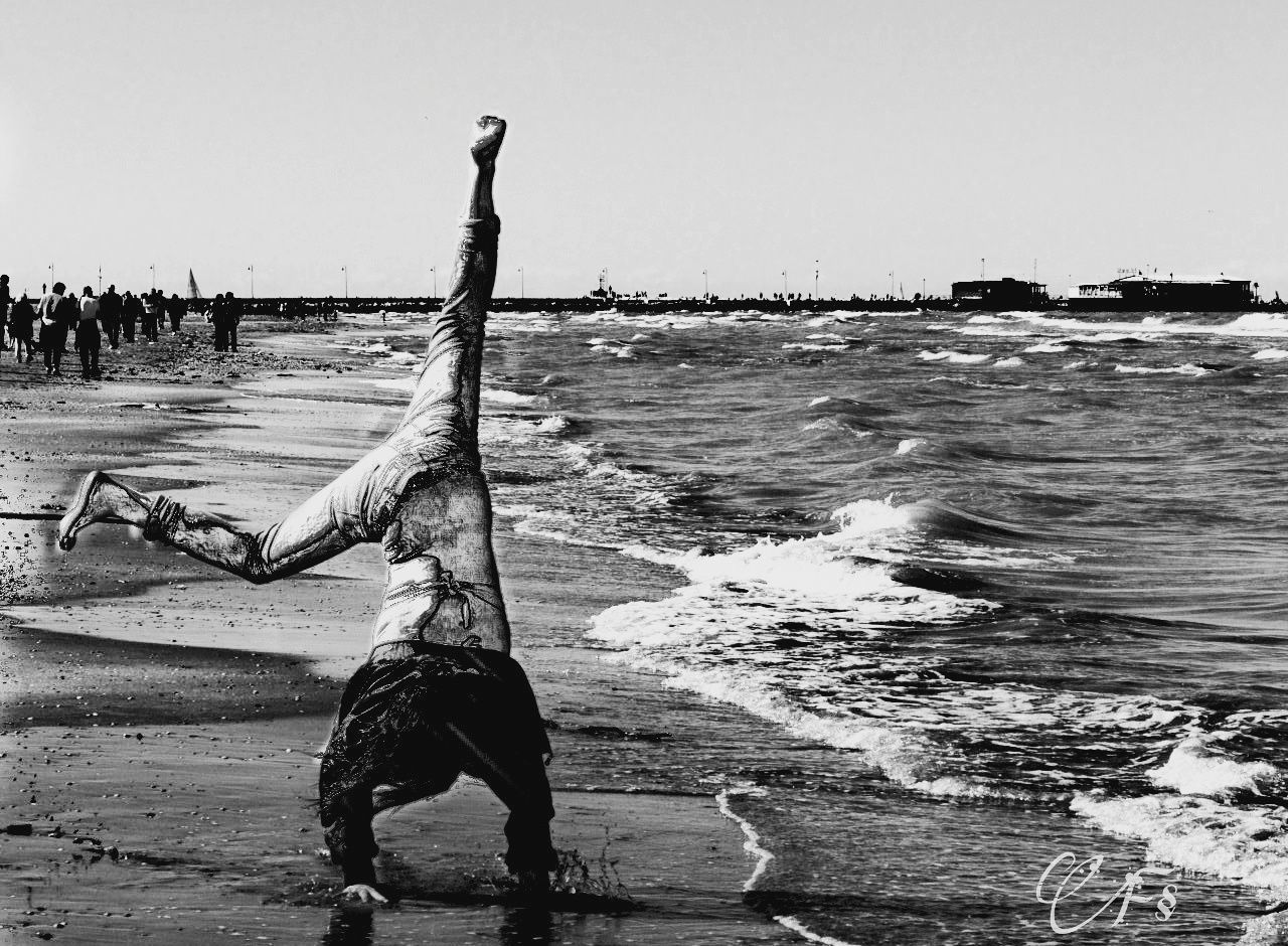 sea, beach, water, full length, real people, one person, sky, vacations, outdoors, lifestyles, wave, horizon over water, enjoyment, arms raised, sand, clear sky, nature, beauty in nature, men, day, people, adult