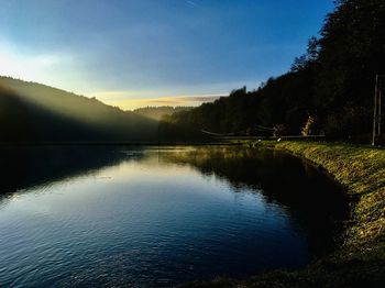 Scenic view of lake against sky during sunset