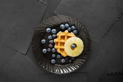 High angle view of plate with waffle and fruit 