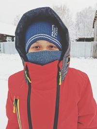 Portrait of young woman covered with snow during winter