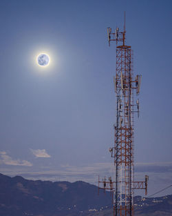 Low angle view of communications tower against sky