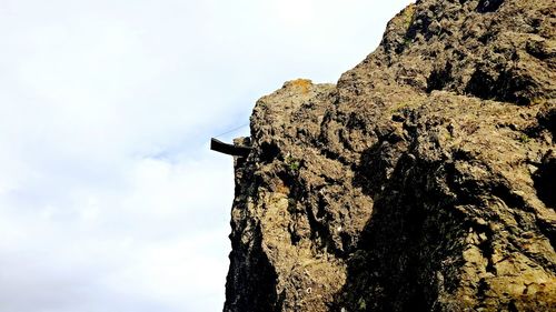 Low angle view of rock formation against sky