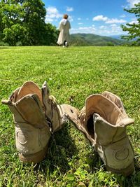 Rear view of people on field against sky