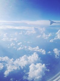 Cropped image of airplane flying over cloudscape