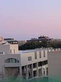 Buildings against clear sky during sunset