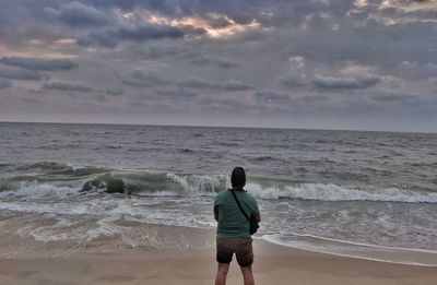 Rear view of man standing on beach