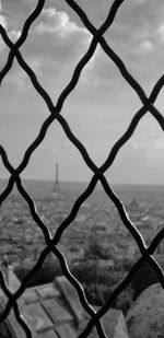 Close-up of chainlink fence against sky