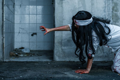 Woman with spooky make-up at abandoned room