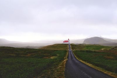 Road amidst landscape against sky