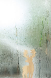 Full frame shot of wet glass window in rainy season